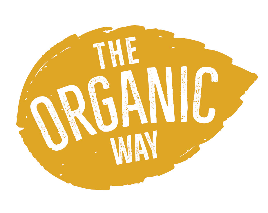 An organic growing space with raised wicker planters full of growing produce