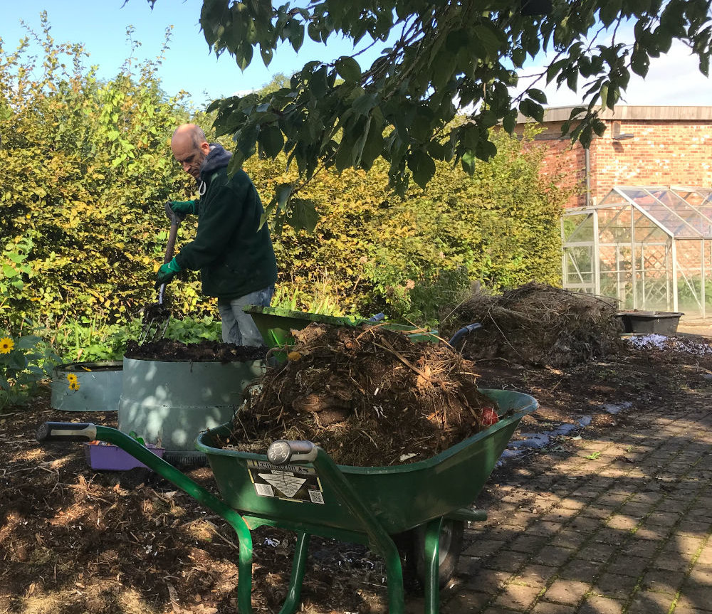 Adding compost to a garden border